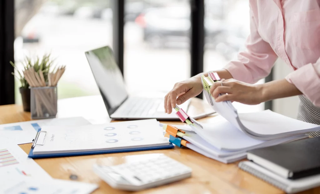 femme en train de classer des documents administratifs sur son bureau